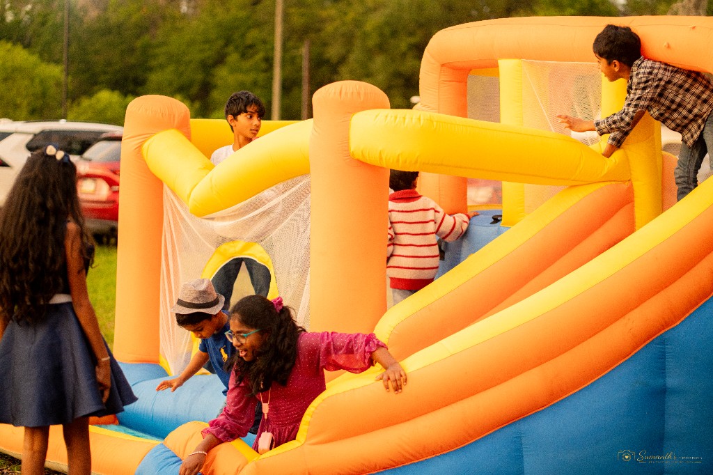 Children playing on a colorful inflatable bounce house