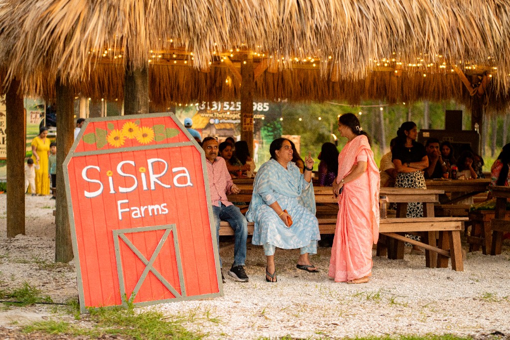 Group of visitors gathered under the farm pavilion